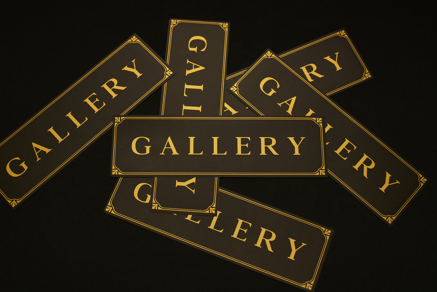Black stickers with gold Gallery text logo