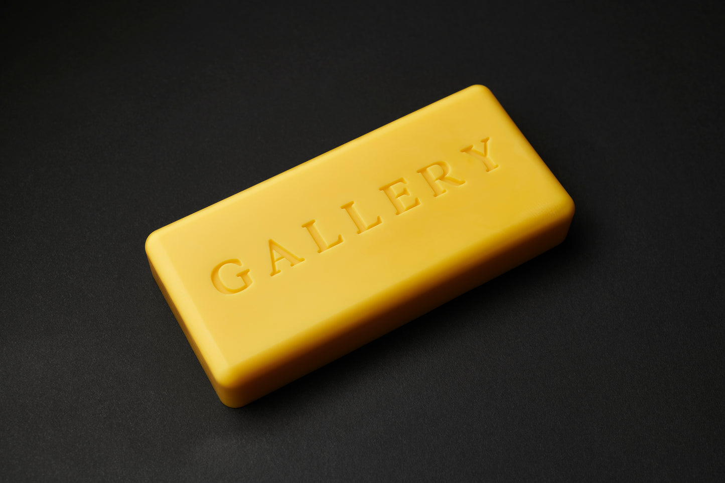 the Apparatus skateboard wax in Gold with debossed Gallery text logo