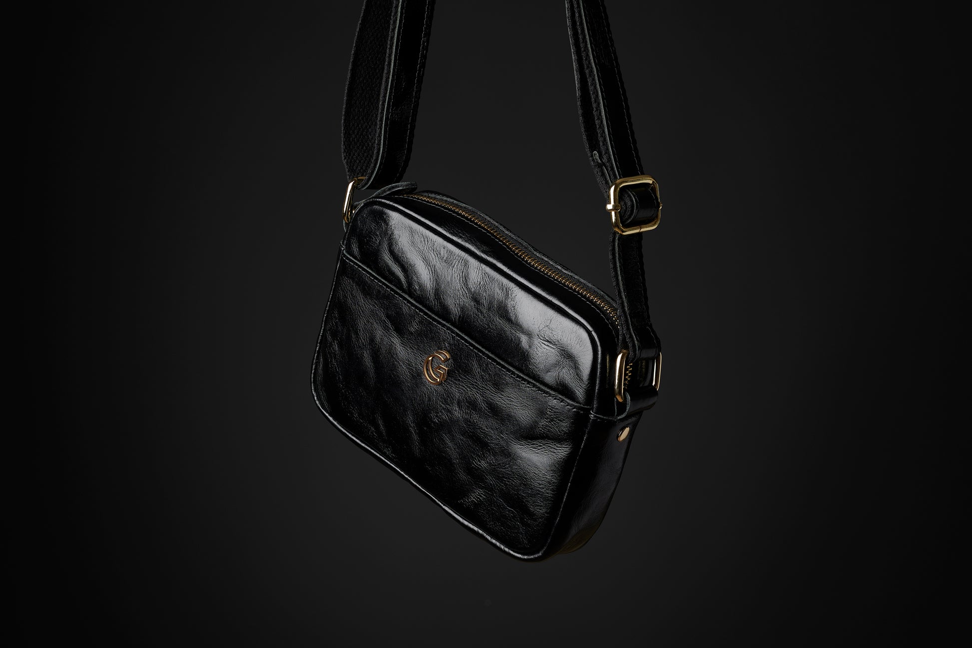 the Acolyte black leather cross body bag with gold hardware