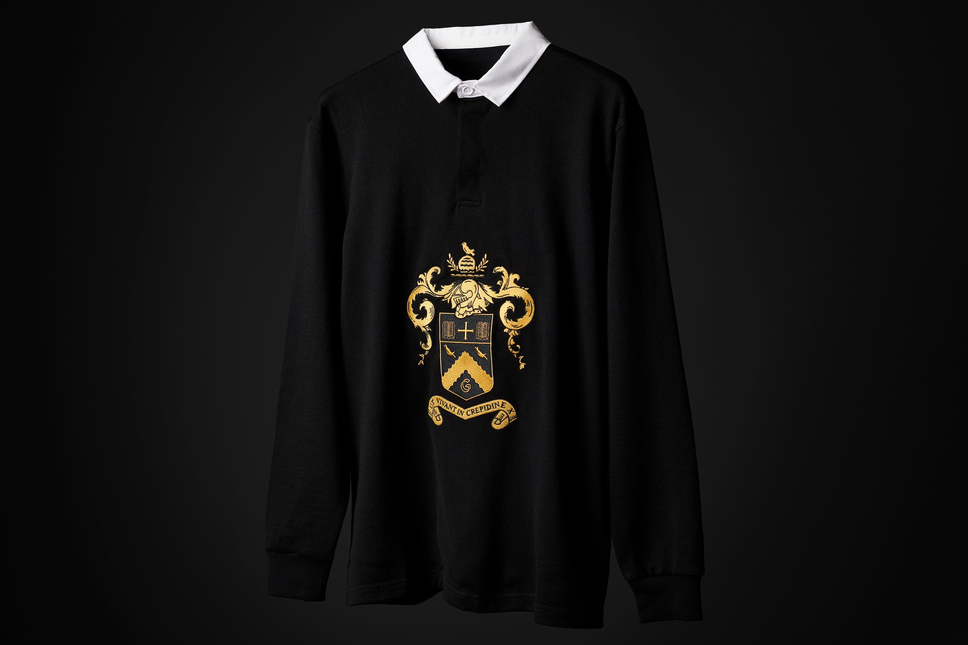 the Heritage rugby shirt, black with a white collar and the Cheltenham coat of arms in gold