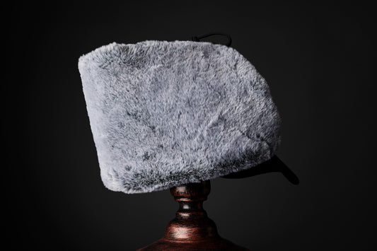 Side view of the Herald trapper cap, showing grey faux fur lining,