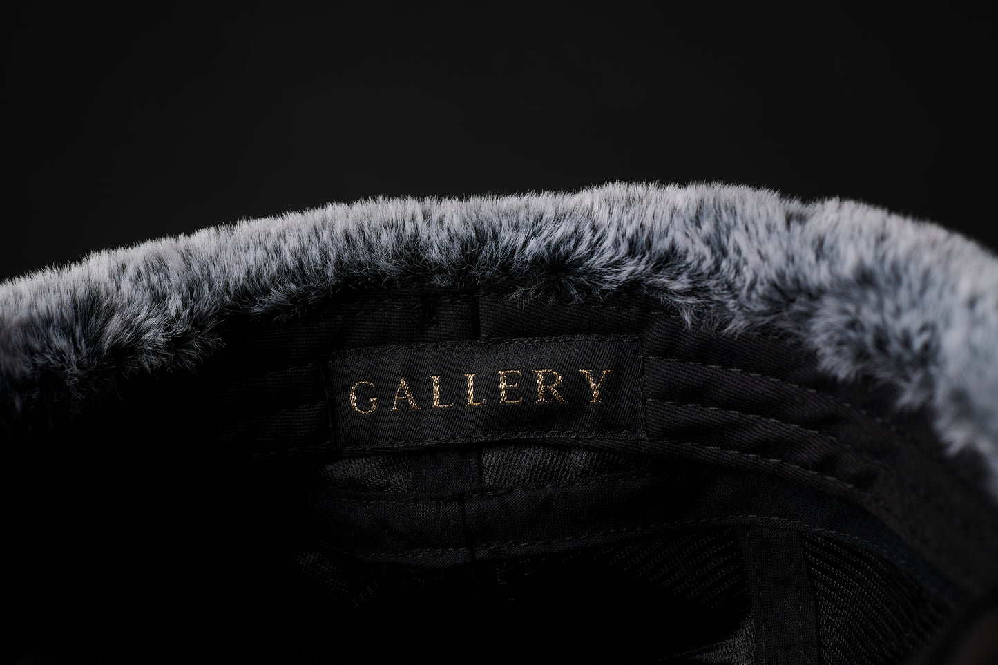 Interior view of the Herald trapper cap, faux fur lining with gold Gallery text logo