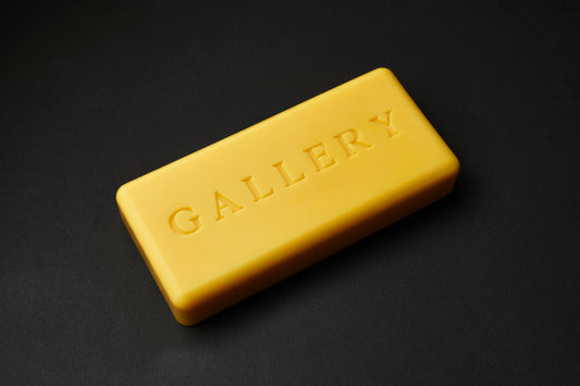 the Apparatus skateboard wax in Gold with debossed Gallery text logo