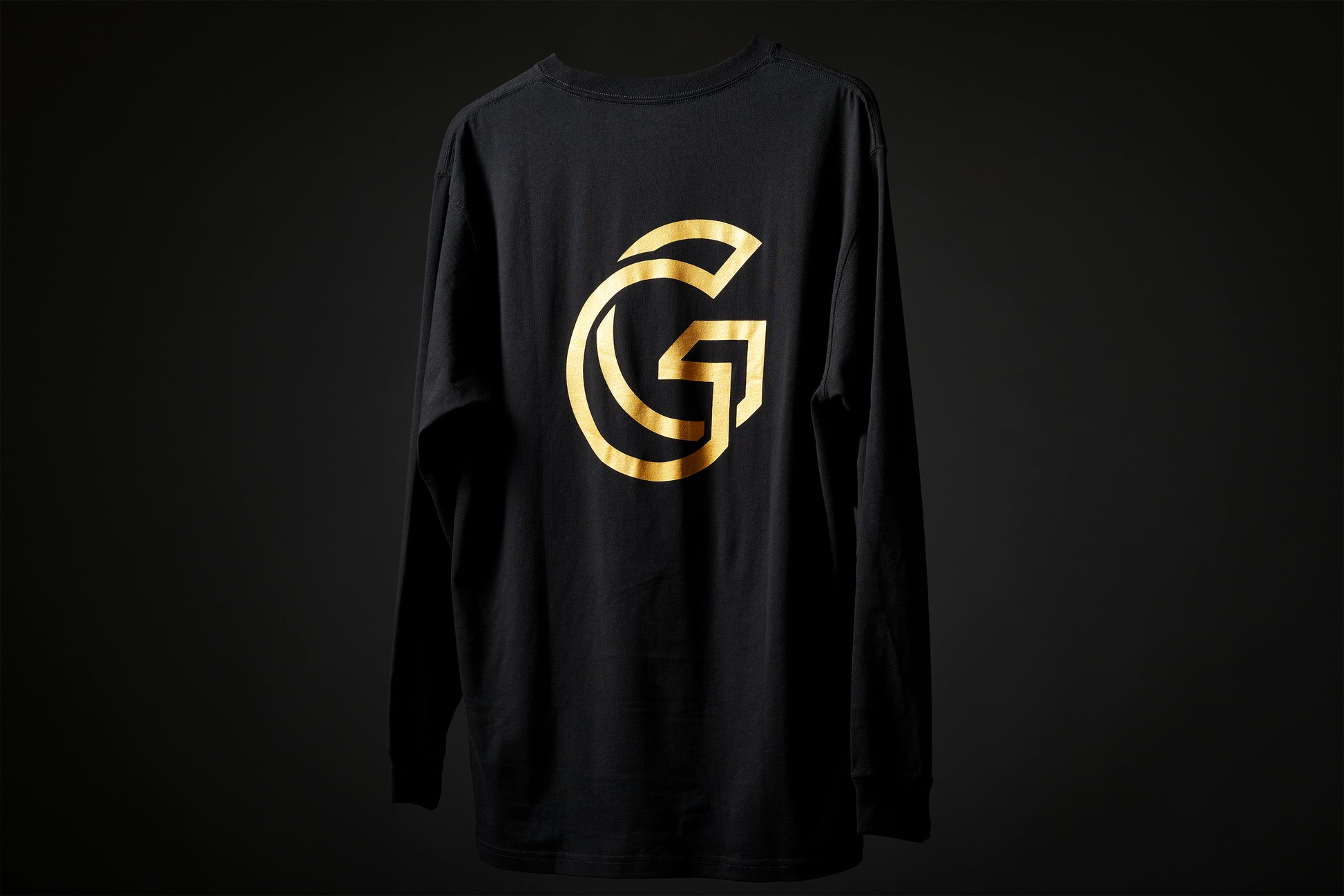 Rear view of the Monarch tee, showing large gold 'G' Gallery logo